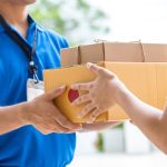 A person handing another person two packages.