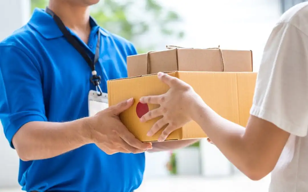 A person handing another person two packages.