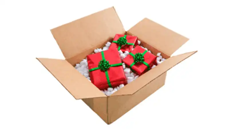 A shipping box full of wrapped presents.