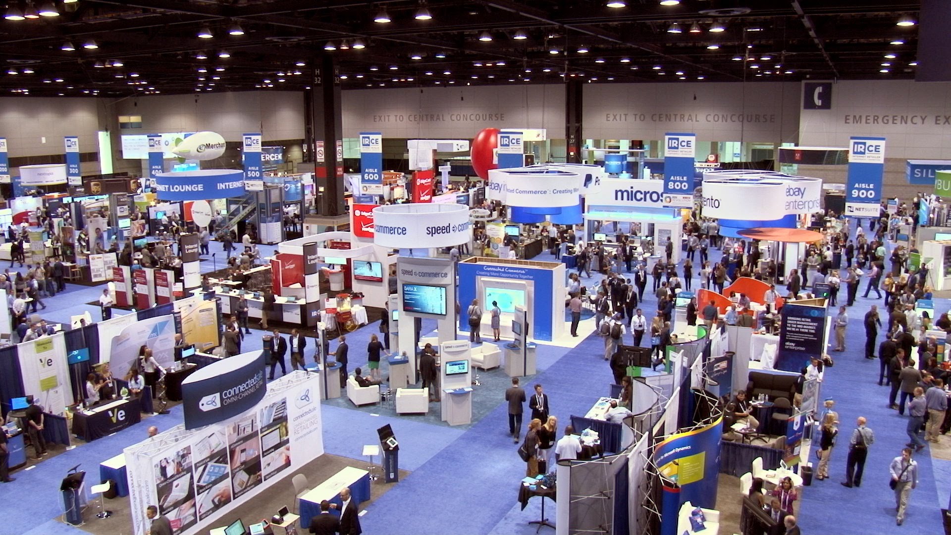 Multiple booths and people attending a tradeshow.
