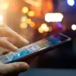 A picture of a smartphone being held and used for ecommerce purchasing