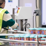 woman packing apparel at fulfillment center