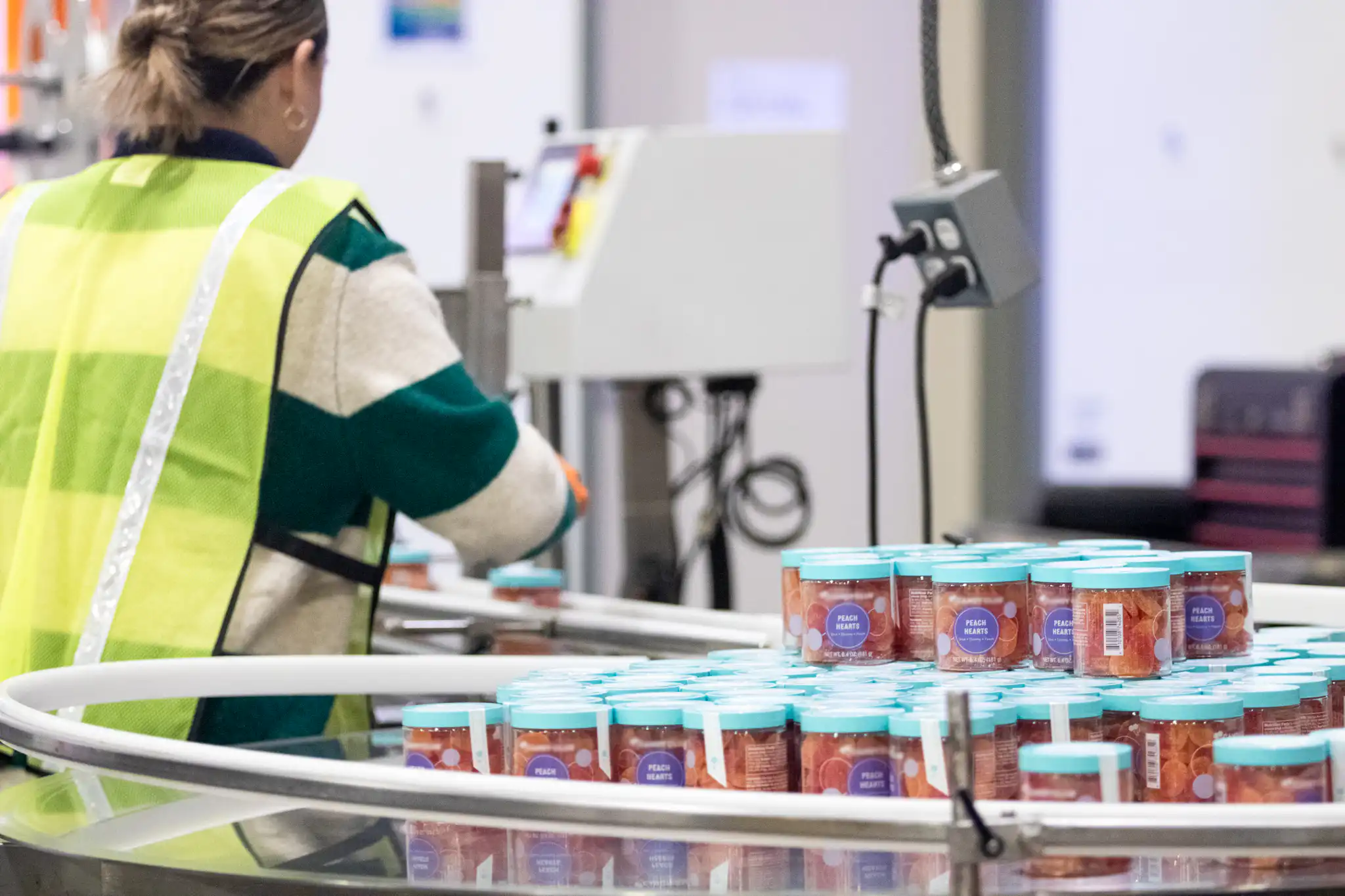 woman packing apparel at fulfillment center